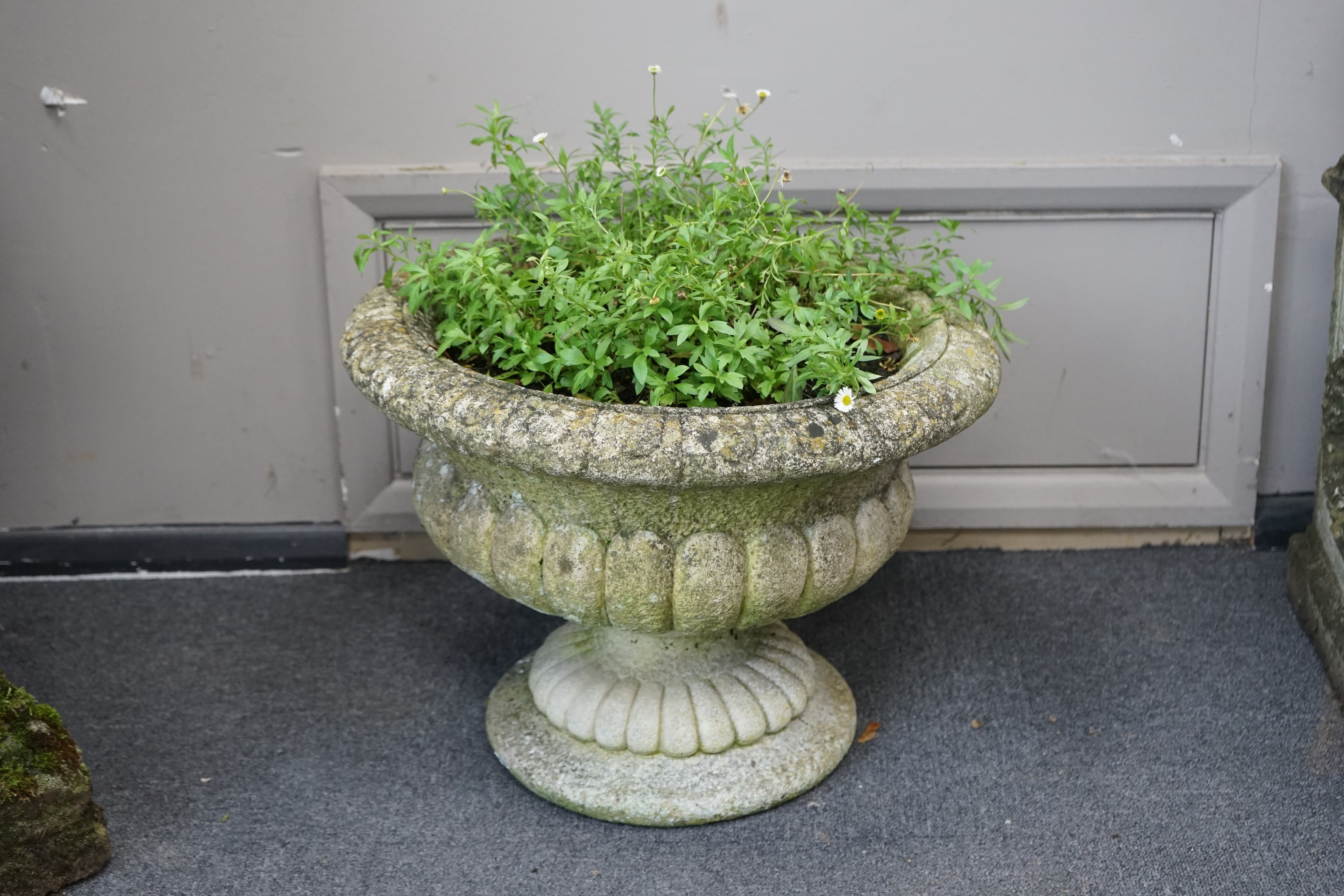 A pair of reconstituted stone circular garden urns